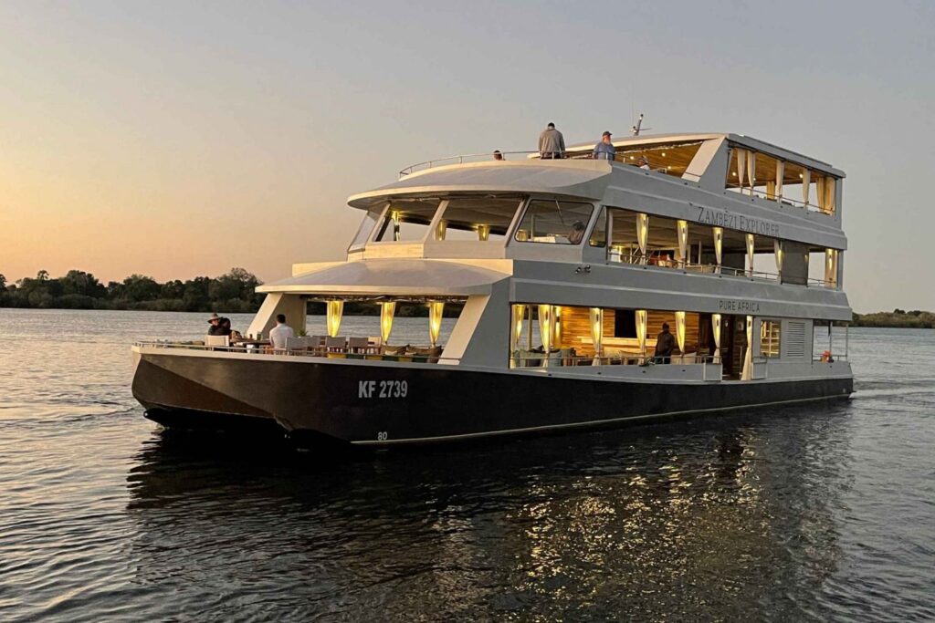 A boat cruise on the Zambezi River with the African sun low on the horizon