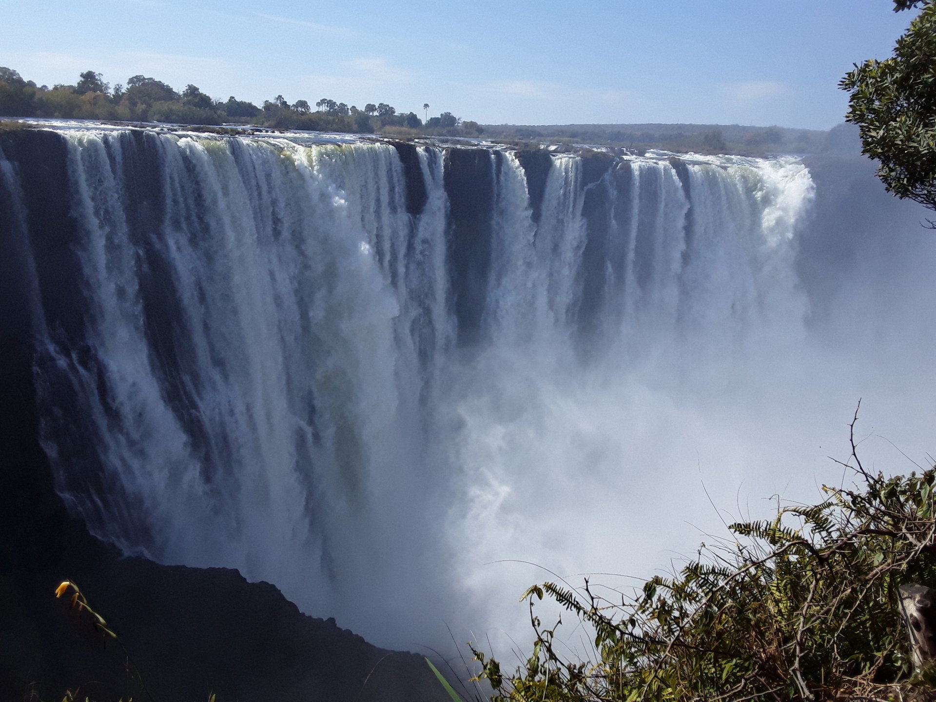 The broad curtain of Victoria Falls cascading into the gorge in Zimbabwe