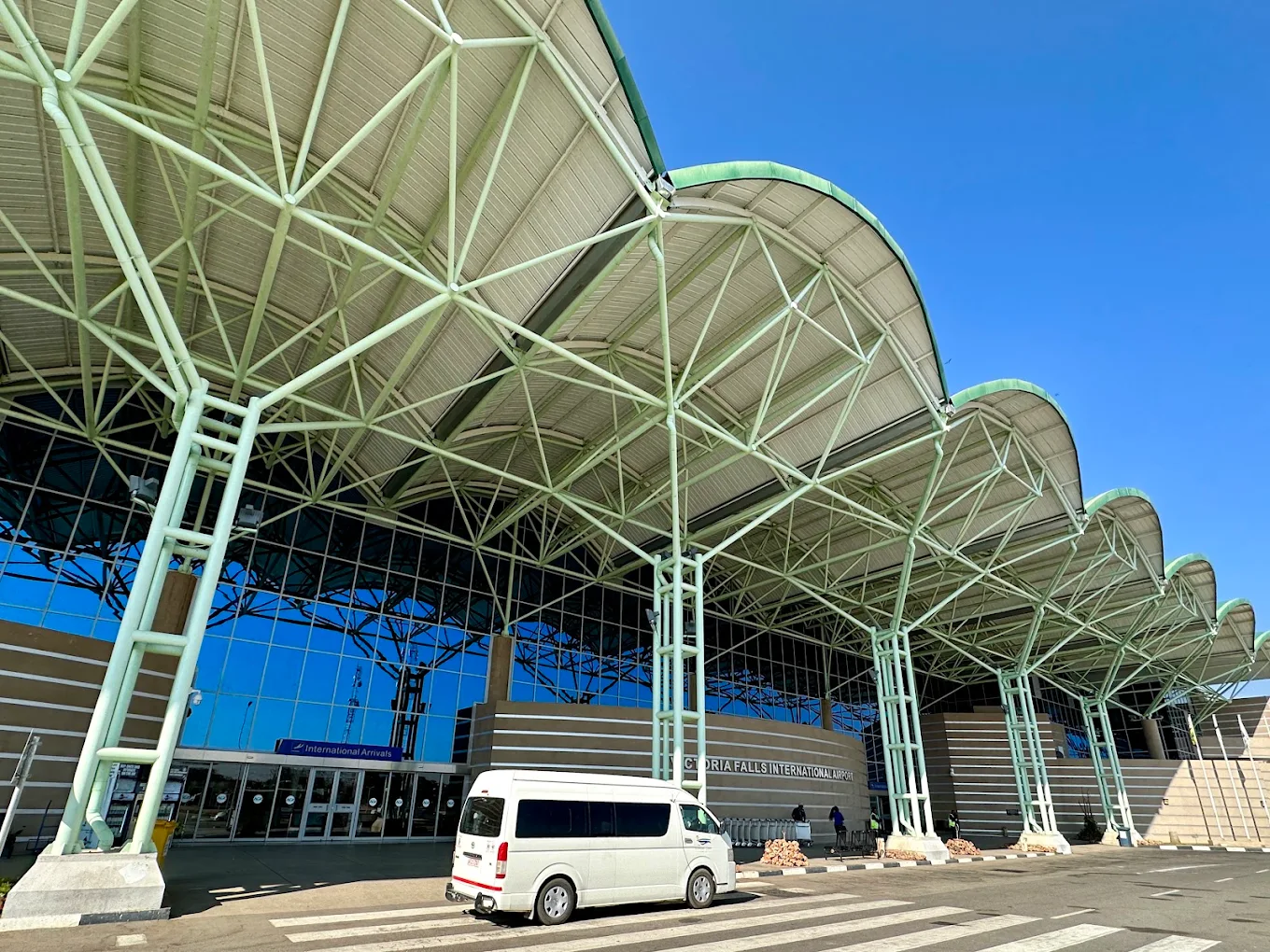 A passenger transfer van outside an airport terminal